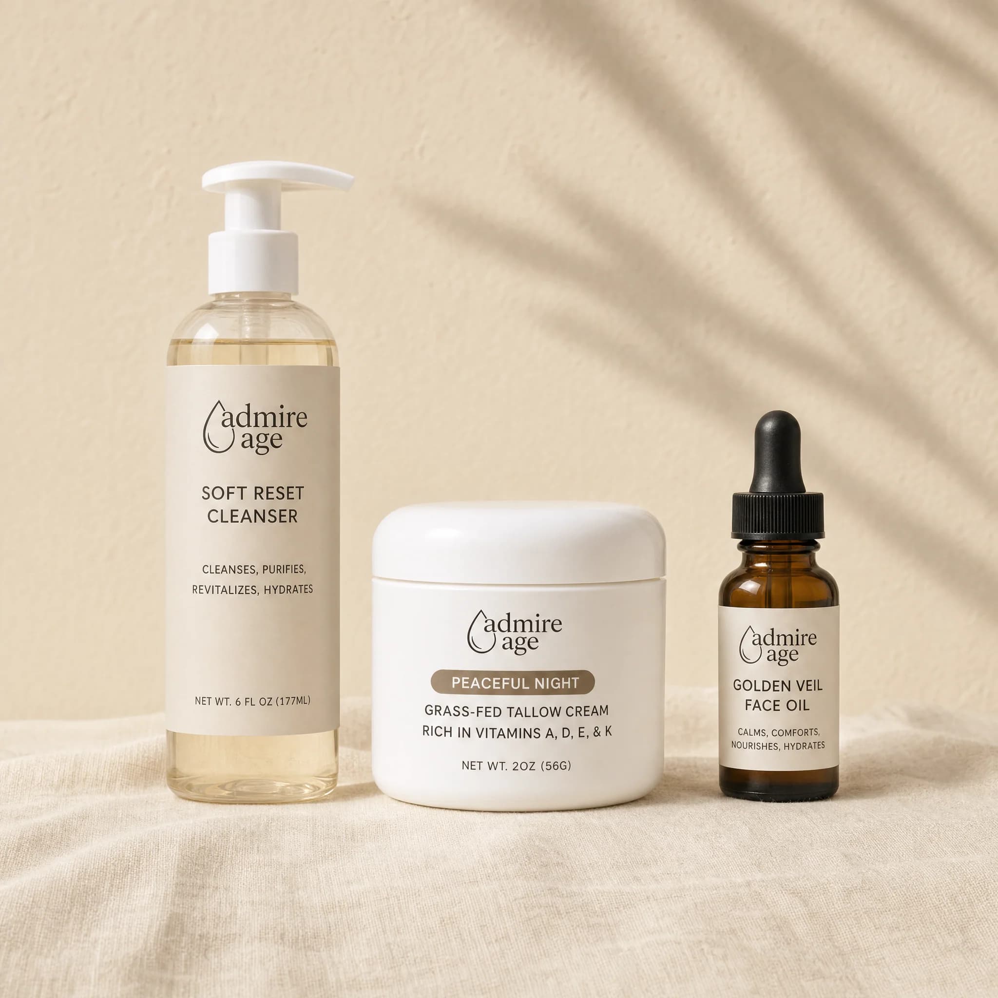 Soft Reset Cleanser, Peaceful Night Tallow Cream, and Golden Veil Face Oil standing together on cream linen — the three-product Dry Weather Rescue Set.