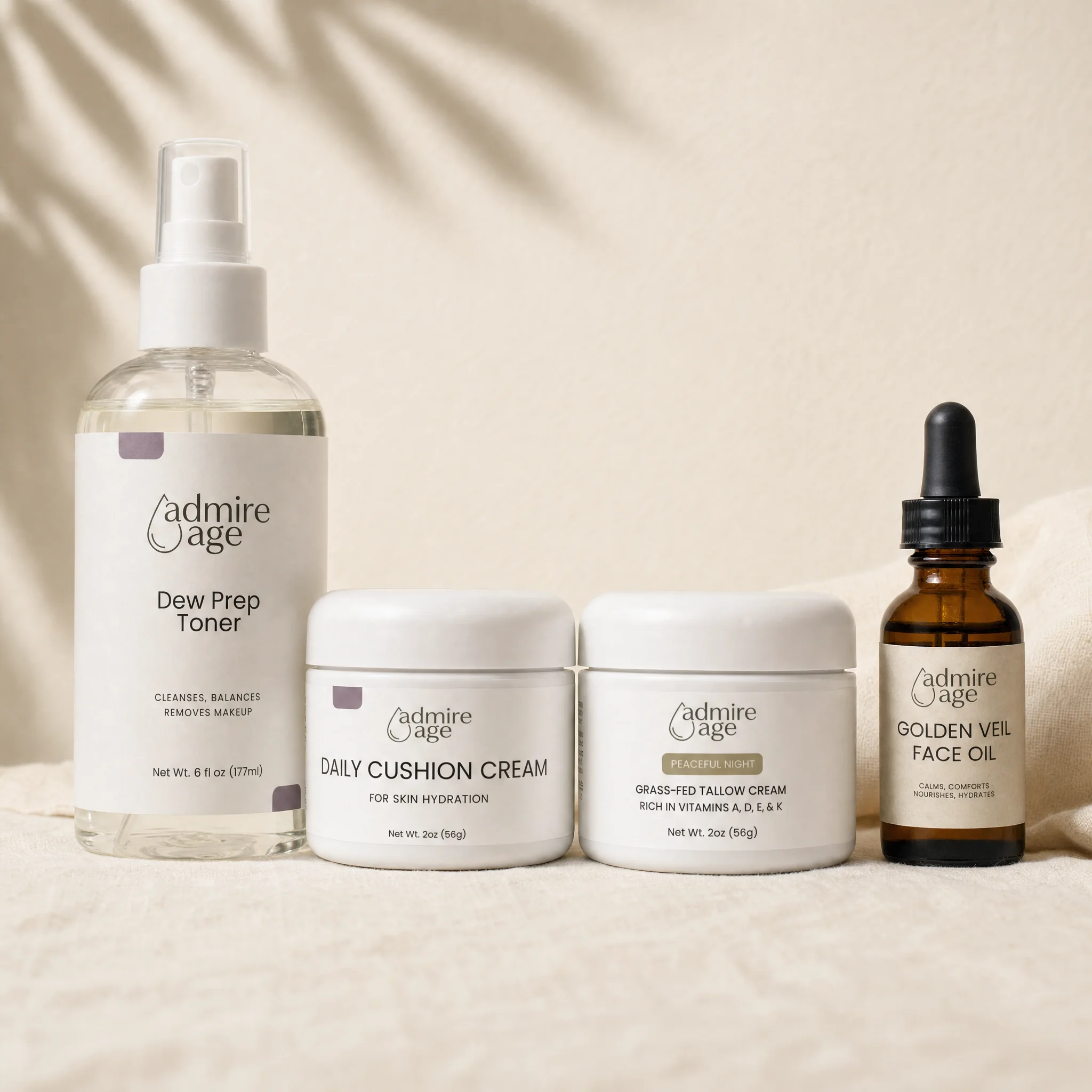 All four Pro-Age Glow Set products together: Dew Prep Toner, Skin Hydration Cream, Peaceful Night Tallow Cream, and Golden Veil Face Oil