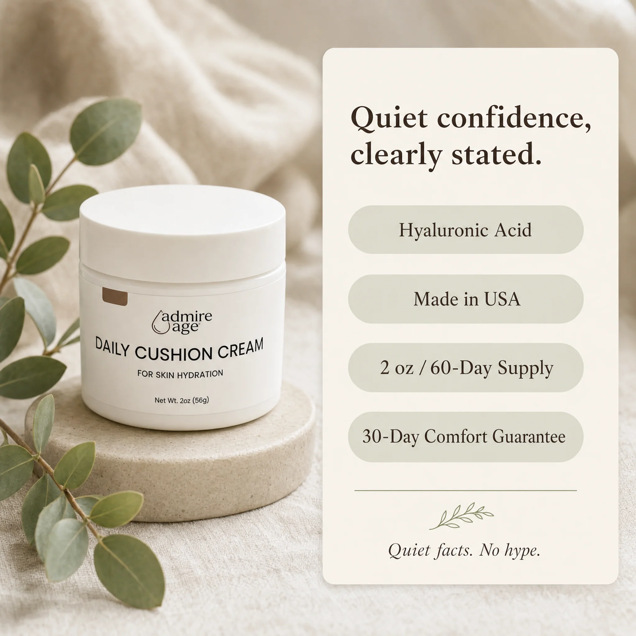 The Daily Cushion Cream jar sits on a small pale stone riser beside a eucalyptus sprig on a soft cream linen surface, with an ivory rounded-corner card to the right titled 'Quiet confidence, clearly stated.' listing four sage-green pill badges — Hyaluronic Acid, Made in USA, 2 oz / 60-Day Supply, 30-Day Comfort Guarantee — above a small leaf flourish and the line 'Quiet facts. No hype.'